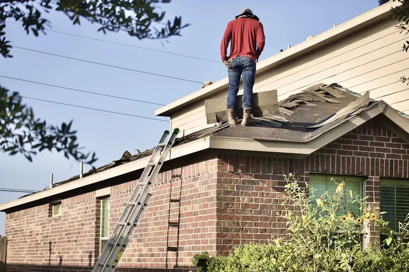 Professional roofer working on a residential roof in Greenbank Farms